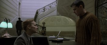 Movie still from “The Bourne Identity” (2002), directed by Doug Liman – A man and a woman looking at each other in front of an open laptop computer; Medium shot, Low angle