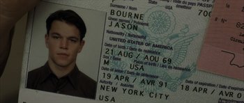 Movie still from “The Bourne Identity” (2002), directed by Doug Liman – A passport with a picture of a young man; Extreme Close Up shot, High angle