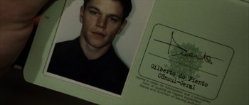 Movie still from “The Bourne Identity” (2002), directed by Doug Liman – A person's photo in a folder; Extreme Close Up shot, Overhead angle
