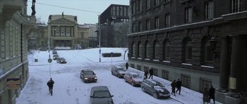 Movie still from “The Bourne Identity” (2002), directed by Doug Liman – Cars parked on the side of a road in the snow; Extreme Wide shot, High angle