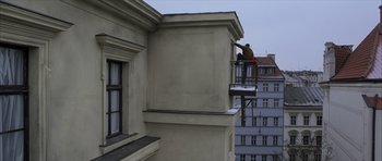 Movie still from “The Bourne Identity” (2002), directed by Doug Liman – A man on a fire escape on the side of a building; Wide shot, High angle