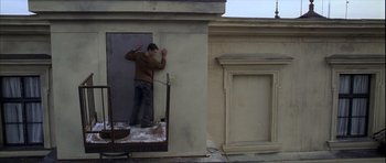 Movie still from “The Bourne Identity” (2002), directed by Doug Liman – A man standing in a doorway of an old building; Wide shot, Low angle