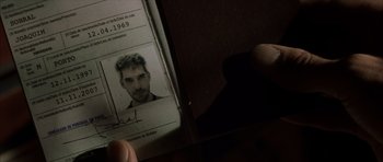 Movie still from “The Bourne Identity” (2002), directed by Doug Liman – A person holding an id card in their hand; Extreme Close Up shot, Overhead angle