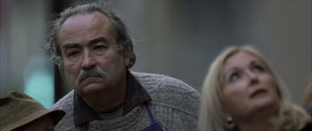 Movie still from “The Bourne Identity” (2002), directed by Doug Liman – An older man with a beard and a mustache; Close Up shot, Over the shoulder angle