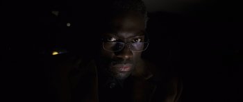 Movie still from “The Bourne Identity” (2002), directed by Doug Liman – A person wearing glasses; Close Up shot, Low angle