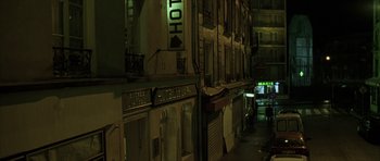 Movie still from “The Bourne Identity” (2002), directed by Doug Liman – A street view of a building at night; Extreme Wide shot, High angle