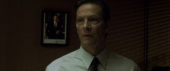 Movie still from “The Bourne Identity” (2002), directed by Doug Liman – A man wearing a white shirt and a tie; Close Up shot, Over the shoulder angle