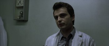 Movie still from “The Bourne Identity” (2002), directed by Doug Liman – A person wearing a shirt and tie; Close Up shot, Over the shoulder angle