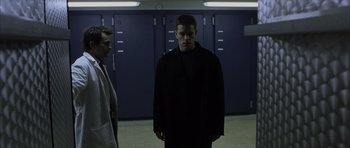 Movie still from “The Bourne Identity” (2002), directed by Doug Liman – A man standing in front of a row of lockers; Medium shot, Low angle