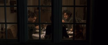 Movie still from “The Bourne Identity” (2002), directed by Doug Liman – A group of people sitting at a dinner table; Medium shot, Over the shoulder angle