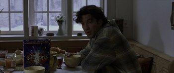 Movie still from “The Bourne Identity” (2002), directed by Doug Liman – A man sitting at a table with a bowl of food; Medium shot, Over the shoulder angle