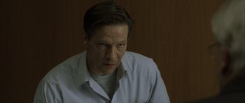 Movie still from “The Bourne Identity” (2002), directed by Doug Liman – A person wearing a dress shirt; Close Up shot, Low angle