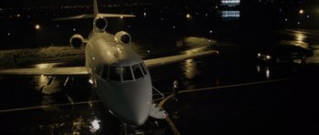 Movie still from “The Bourne Identity” (2002), directed by Doug Liman – An airplane parked at an airport at night time; Extreme Wide shot, High angle
