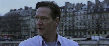 Movie still from “The Bourne Identity” (2002), directed by Doug Liman – A person with a building in the background; Close Up shot, Low angle