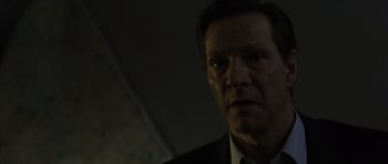 Movie still from “The Bourne Identity” (2002), directed by Doug Liman – A person wearing a suit and tie; Close Up shot, Low angle