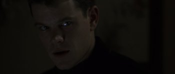 Movie still from “The Bourne Identity” (2002), directed by Doug Liman – A person's face in the dark; Close Up shot, Low angle