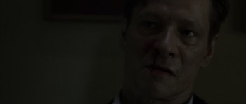 Movie still from “The Bourne Identity” (2002), directed by Doug Liman – A person with a knife in his mouth; Close Up shot, Low angle