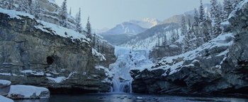 Movie still from “The Bourne Legacy” (2012), directed by Tony Gilroy – A waterfall in the middle of a snowy mountain; Extreme Wide shot, High angle