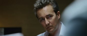 Movie still from “The Bourne Legacy” (2012), directed by Tony Gilroy – A person wearing a white shirt; Close Up shot, Over the shoulder angle