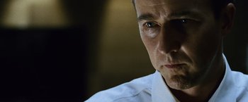 Movie still from “The Bourne Legacy” (2012), directed by Tony Gilroy – A person wearing a white shirt; Close Up shot, Low angle