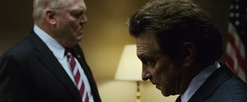Movie still from “The Bourne Legacy” (2012), directed by Tony Gilroy – Two men in business suits looking at each other; Close Up shot, Over the shoulder angle