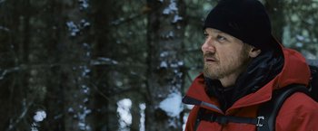 Movie still from “The Bourne Legacy” (2012), directed by Tony Gilroy – A person wearing a jacket and hat; Close Up shot, Low angle