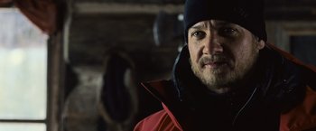 Movie still from “The Bourne Legacy” (2012), directed by Tony Gilroy – A person wearing a jacket and a hat; Close Up shot, Over the shoulder angle