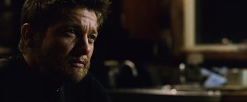 Movie still from “The Bourne Legacy” (2012), directed by Tony Gilroy – A person wearing a black shirt; Close Up shot, Over the shoulder angle