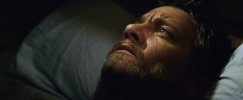 Movie still from “The Bourne Legacy” (2012), directed by Tony Gilroy – A person with a beard; Close Up shot, High angle