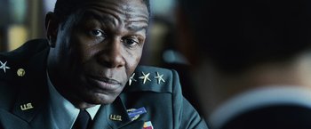 Movie still from “The Bourne Legacy” (2012), directed by Tony Gilroy – A person wearing a uniform; Close Up shot, Low angle