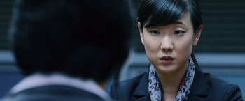 Movie still from “The Bourne Legacy” (2012), directed by Tony Gilroy – A person wearing a suit and tie; Close Up shot, Over the shoulder angle