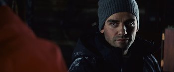 Movie still from “The Bourne Legacy” (2012), directed by Tony Gilroy – A person wearing a jacket and a hat; Close Up shot, Over the shoulder angle