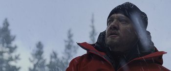 Movie still from “The Bourne Legacy” (2012), directed by Tony Gilroy – A person wearing a red jacket; Close Up shot, Low angle