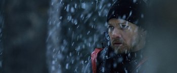 Movie still from “The Bourne Legacy” (2012), directed by Tony Gilroy – A person wearing a jacket and hat in the snow; Close Up shot, Low angle