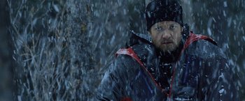 Movie still from “The Bourne Legacy” (2012), directed by Tony Gilroy – A man standing in the snow with a black jacket on; Close Up shot, Over the shoulder angle