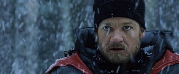 Movie still from “The Bourne Legacy” (2012), directed by Tony Gilroy – A person wearing a hat and a jacket; Close Up shot, Over the shoulder angle
