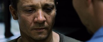 Movie still from “The Bourne Legacy” (2012), directed by Tony Gilroy – A man's face with tears in his eyes; Close Up shot, Low angle