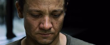 Movie still from “The Bourne Legacy” (2012), directed by Tony Gilroy – A man's face with tears in his eyes; Close Up shot, Low angle