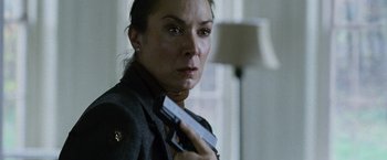 Movie still from “The Bourne Legacy” (2012), directed by Tony Gilroy – A woman is holding a gun in her hand; Close Up shot, Low angle