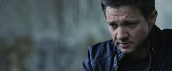 Movie still from “The Bourne Legacy” (2012), directed by Tony Gilroy – A person wearing a black jacket; Close Up shot, Low angle