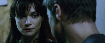Movie still from “The Bourne Legacy” (2012), directed by Tony Gilroy – A man and a woman looking at one another in a mirror; Close Up shot, Over the shoulder angle