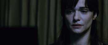Movie still from “The Bourne Legacy” (2012), directed by Tony Gilroy – A woman's face in the dark; Close Up shot, Over the shoulder angle