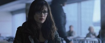 Movie still from “The Bourne Legacy” (2012), directed by Tony Gilroy – A person wearing glasses and a jacket; Close Up shot, Over the shoulder angle