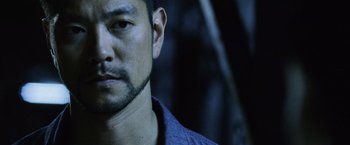 Movie still from “The Bourne Legacy” (2012), directed by Tony Gilroy – A person wearing a blue shirt; Close Up shot, Low angle