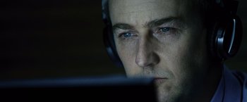 Movie still from “The Bourne Legacy” (2012), directed by Tony Gilroy – A person wearing headphones; Close Up shot, Over the shoulder angle