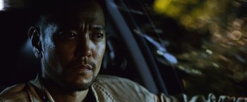 Movie still from “The Bourne Legacy” (2012), directed by Tony Gilroy – A man's face in the dark; Close Up shot, Low angle