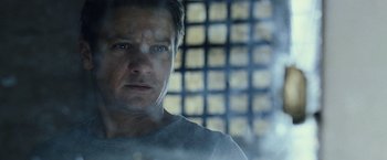 Movie still from “The Bourne Legacy” (2012), directed by Tony Gilroy – A person in a room near a window; Close Up shot, Low angle