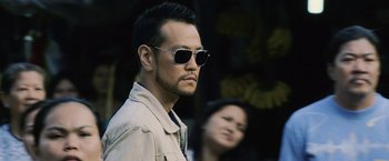 Movie still from “The Bourne Legacy” (2012), directed by Tony Gilroy – A person wearing sunglasses; Close Up shot, Low angle