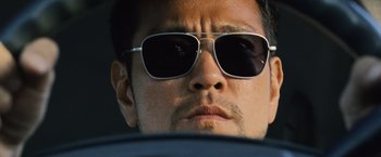 Movie still from “The Bourne Legacy” (2012), directed by Tony Gilroy – A person wearing sunglasses; Close Up shot, Low angle