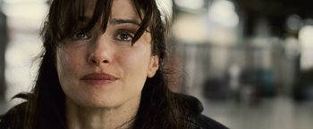 Movie still from “The Bourne Legacy” (2012), directed by Tony Gilroy – A woman's face with long brown hair; Close Up shot, Over the shoulder angle